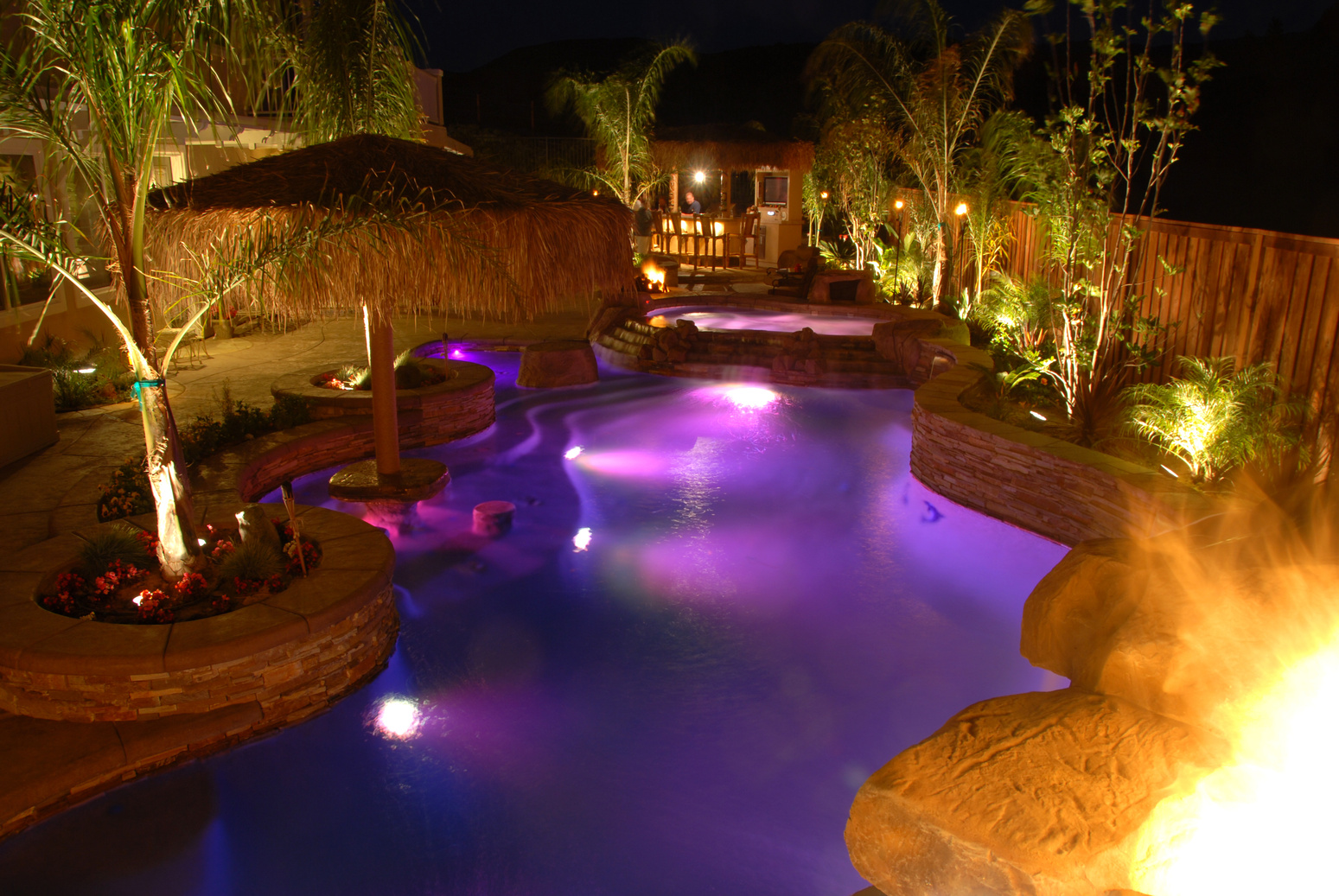 Swimming pool at night lite up purple